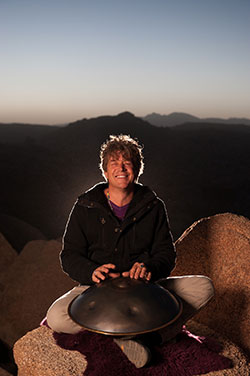 man sitting on a rock