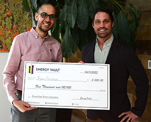 two men holding an oversized check