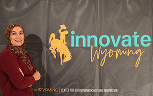 woman standing beside a banner