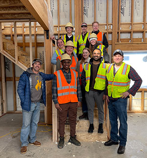 group of people standing in a house under construction
