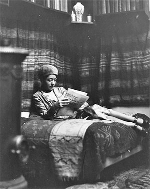vintage photo of a woman reading on a bed