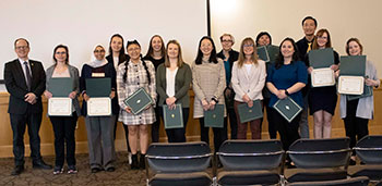 group of people posing with awards