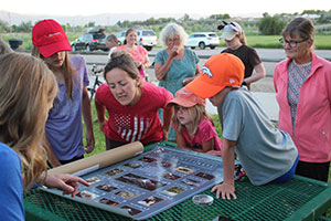 people looking at a poster on a table