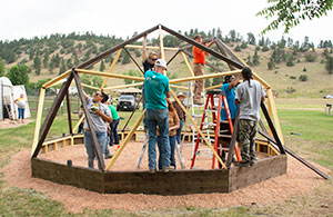 people building a small geodesic dome