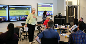 woman lecturing room of people