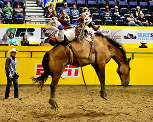 man riding a bucking bronco