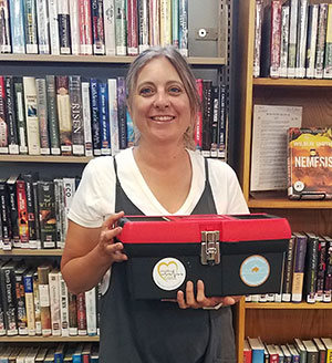 woman holding a red and black plastic box 