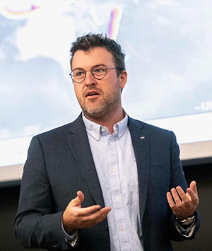 man speaking to a classroom