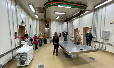 people in a large room with a large metal table