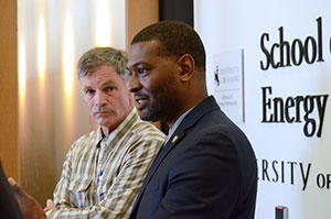 two men standing at the front of a room