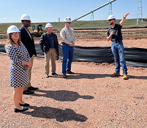 group of people outside wearing hard hats