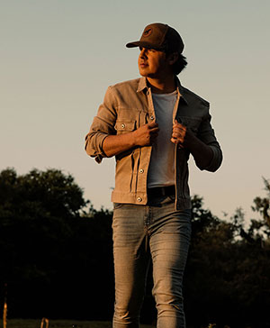 man walking outside in low light