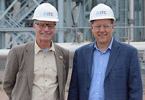 men wearing hard hats posing together outside