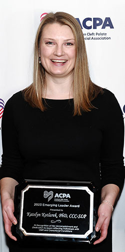 woman holding an award