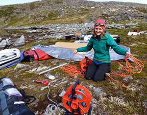 woman outdoors surrounded by equipment