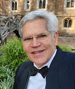 man in a bow tie standing outside