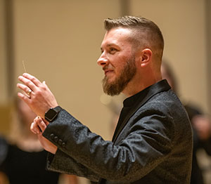 man conducting singers