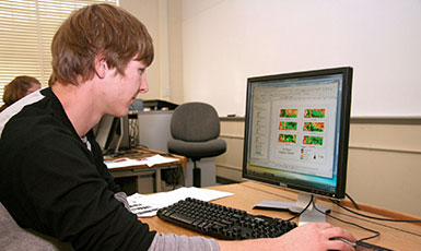 man sitting at a computer