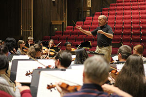 man conducting orchestra practice