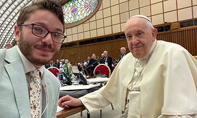 man posing with the Pope