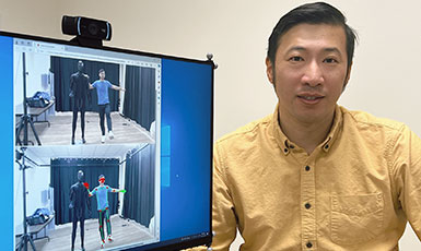 man with a screen displaying two images of people