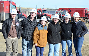 group of people in hardhats posing outside