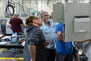 people looking inside a machine