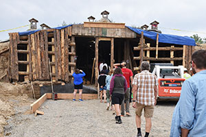 people entering a rustic building