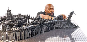 man with a huge Lego sculpture