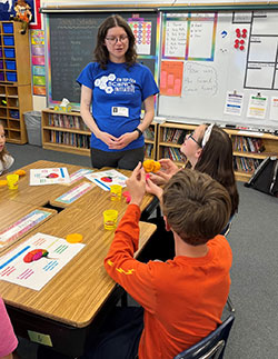 Woman talking to children in a classroom