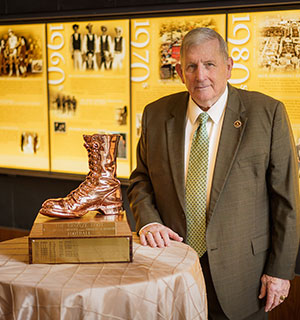 older man posing with the Bronze Boot