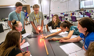 teenagers working around a large table