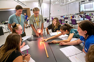 teenagers working around a large table