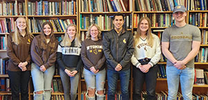 group standing in front of bookshelves