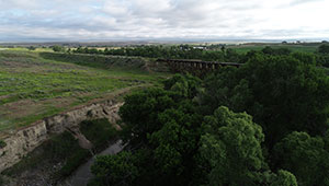 overhead view of an area with woods and grassland