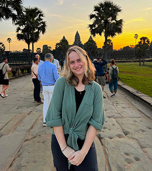 woman posing with a sunset in the background