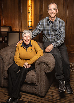 woman and man posing on a large chair