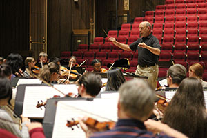 man conducting musicians