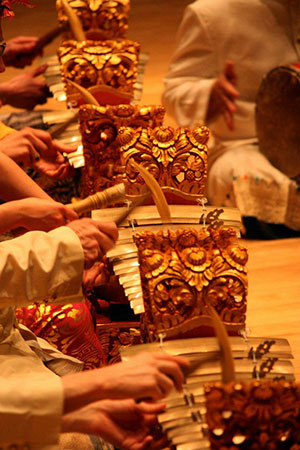 a close up of hands playing gamelan instruments