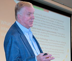 man standing in front of a screen with words on it