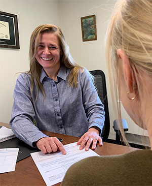 woman at a desk talking to someone