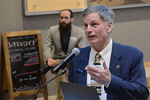 man speaking into a microphone at a podium