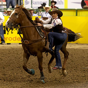 woman dismounting from a running horse