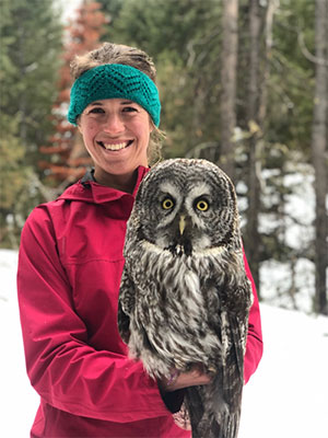 woman holding a large owl