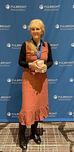 woman standing in front of a blue background