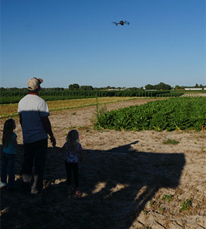 person flying a drone over a field