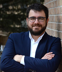 man leaning against a wall outside