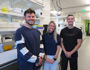 three people standing in a lab