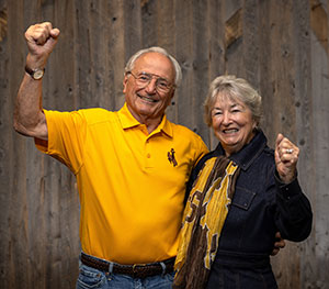 man and woman in Wyoming gear standing together