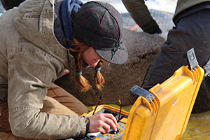 person working with small machine outdoors